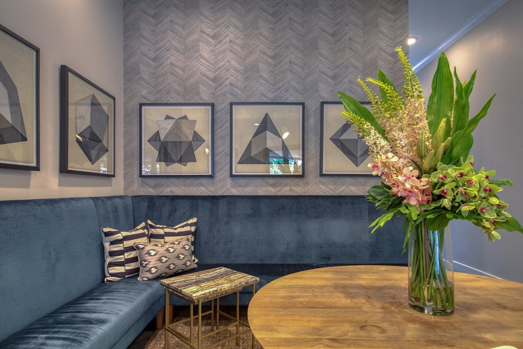 a large wooden table with a vase of flowers on top of it