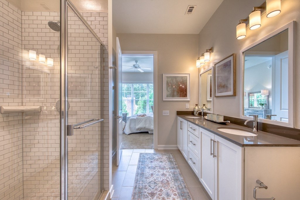 a bathroom with a shower and a sink and a mirror