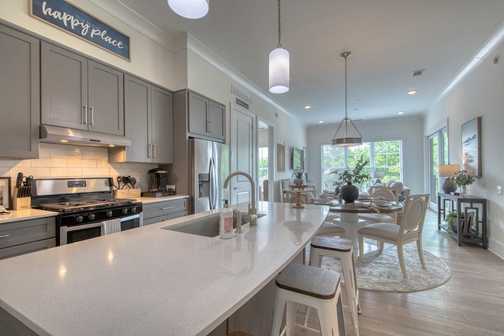 an open kitchen and dining room with a large counter top