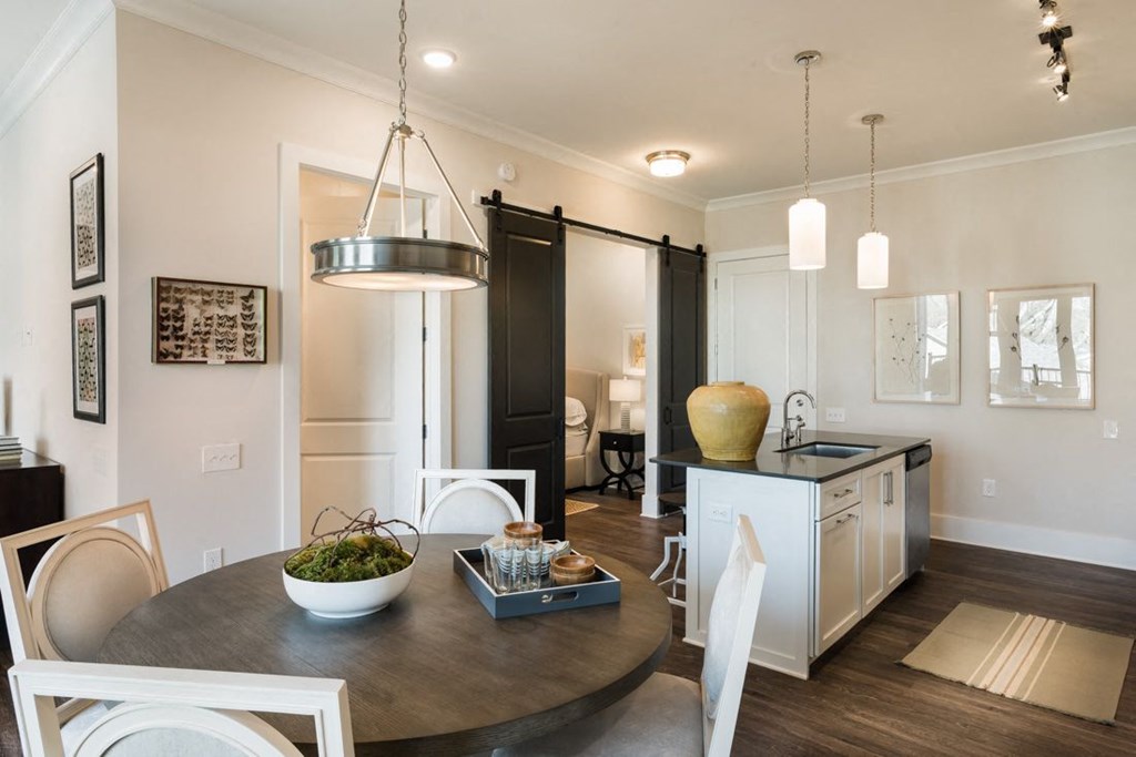 a kitchen and dining room with a table and chairs