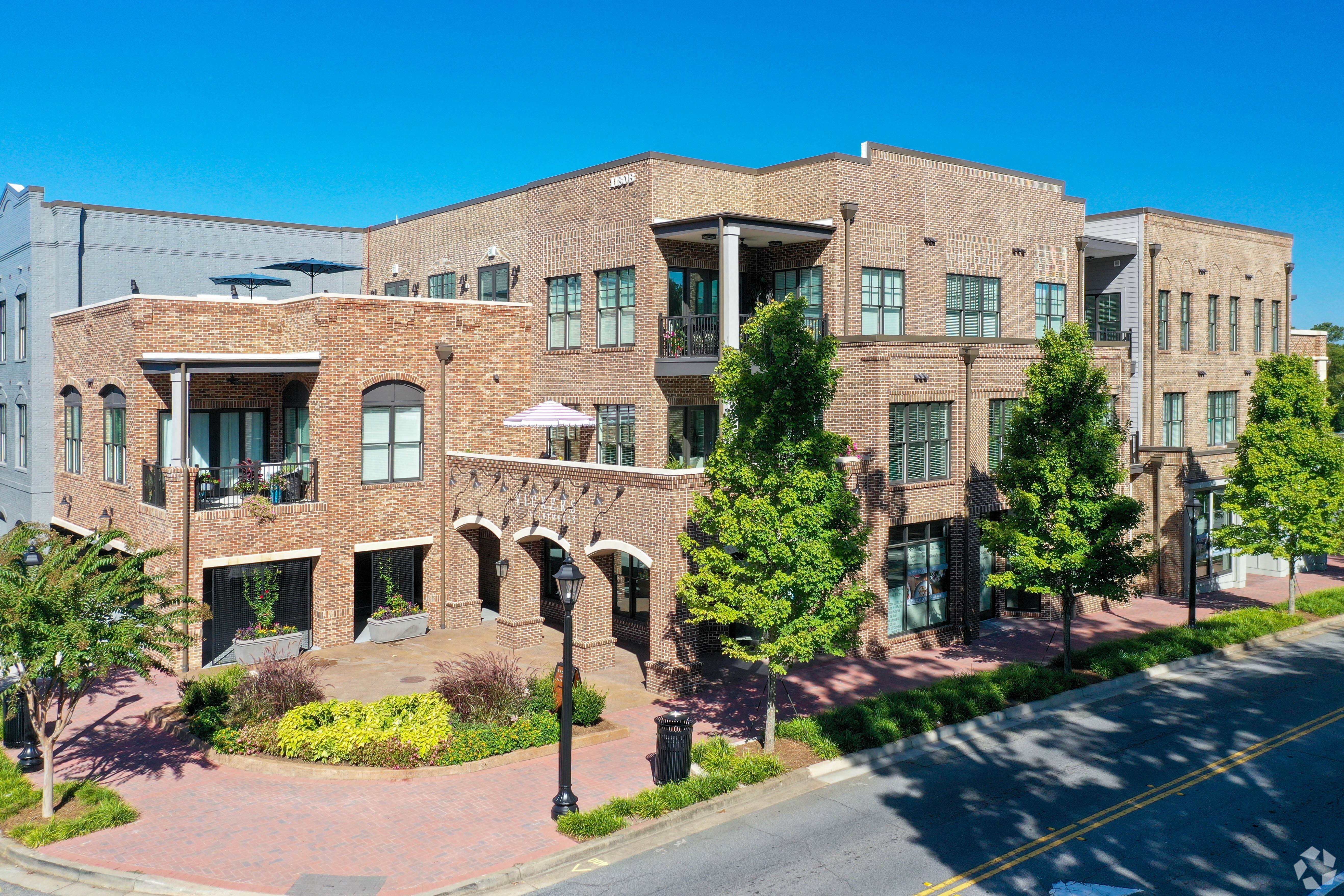 a large brick building with trees in front of it
