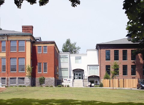 a group of buildings on the side of a lawn