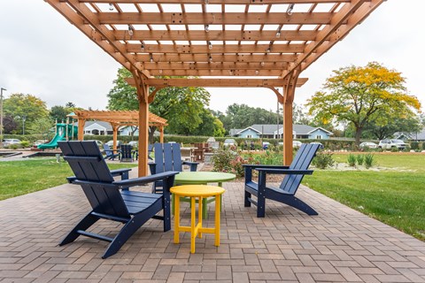 a patio with chairs and a pergola