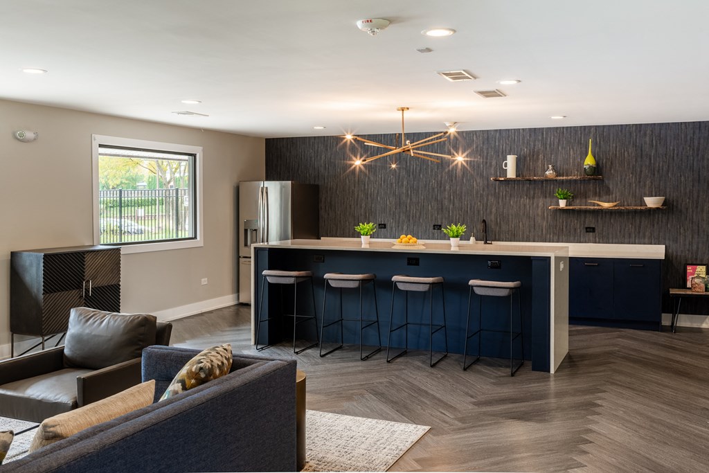 a kitchen with a bar and a living room with a couch