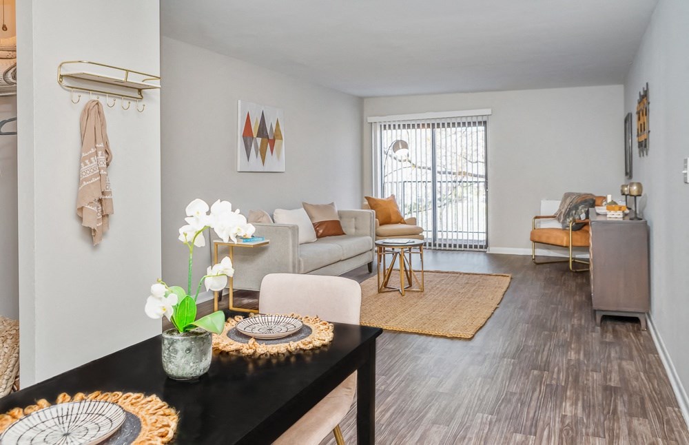 a living room with a table and a couch and a window
