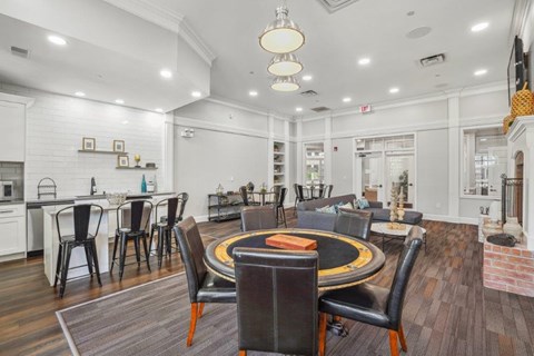 Community game room with a round gaming table and additional recreational seating