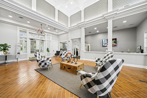A living room with a checkered chair and a wooden coffee table.