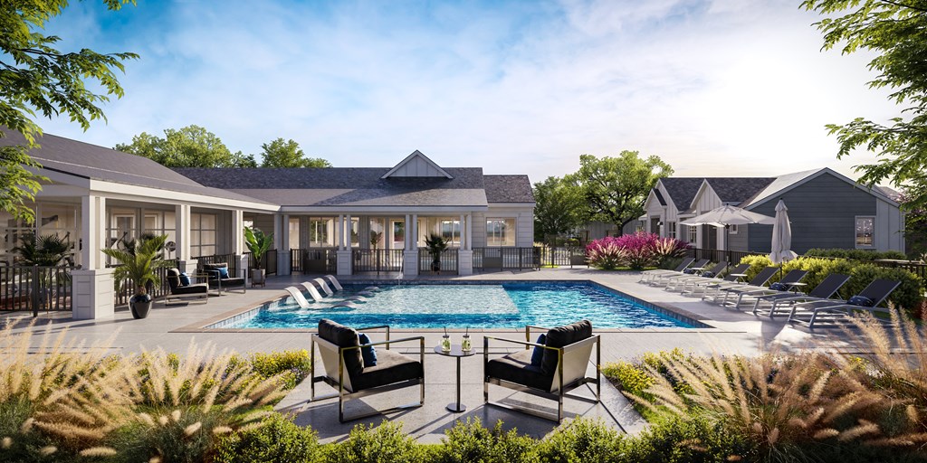 a swimming pool in front of a house with lounge chairs and a resort style pool