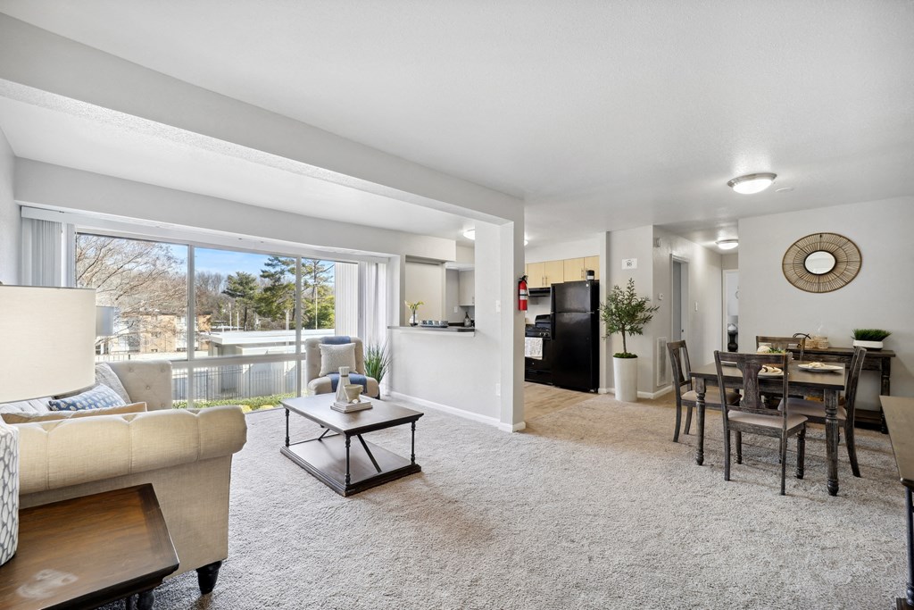 the living room and dining room of an apartment with a large window at Capitol Heights, Capitol Heights, Maryland, 20743