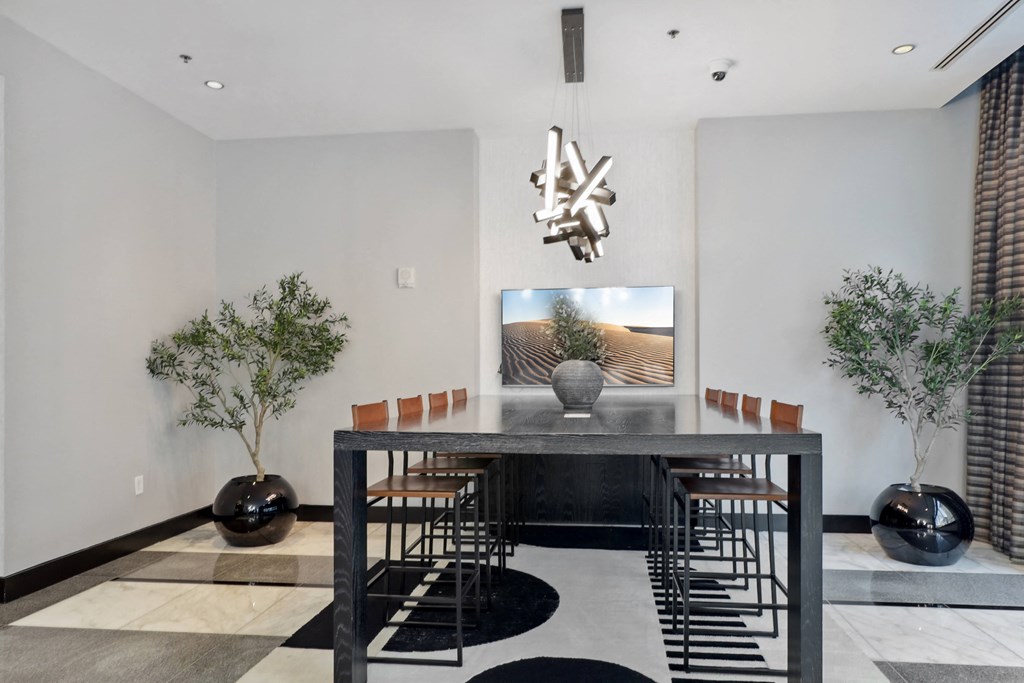 a dining room with a table and chairs and a tv on the wall at The Zenith, Maryland