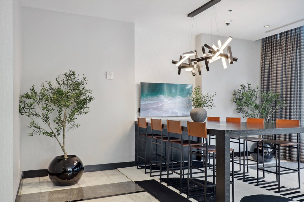 a dining room with a table and chairs and a chandelierat The Zenith, Maryland, 21201