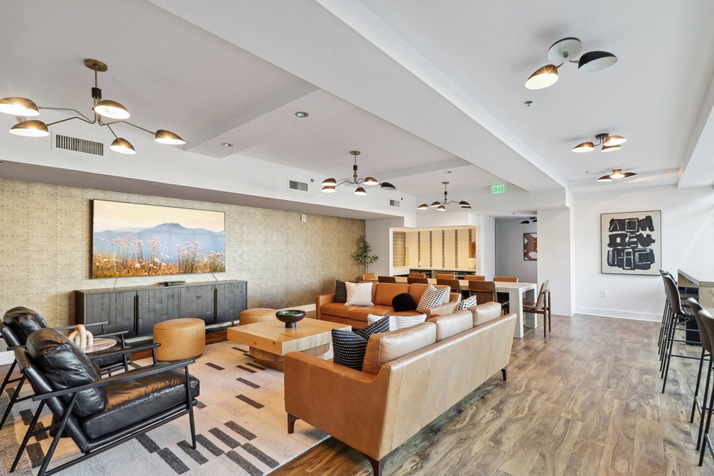 a living room with couches and chairs and a table and chairs in a lobby at The Zenith, Baltimore, Maryland