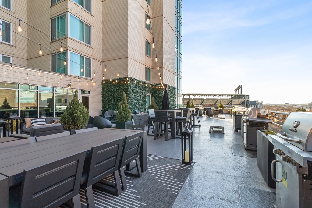 a lounge area with a couch and chairs in front of a tall building at The Zenith, Baltimore