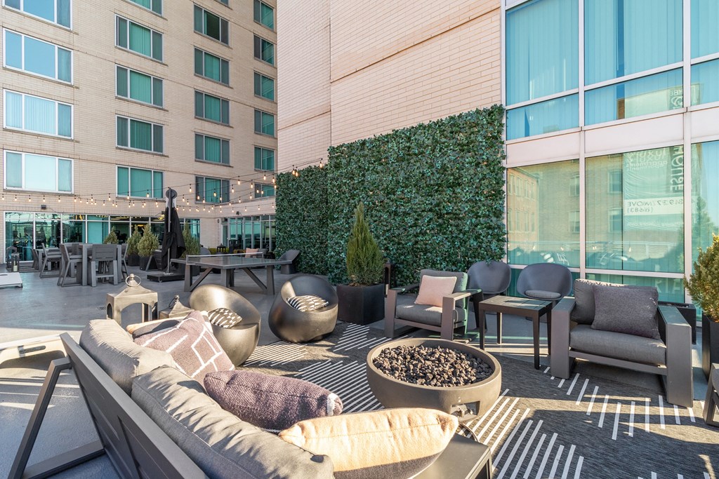 a lounge area with a couch and chairs in front of a tall building at The Zenith, Baltimore, Maryland