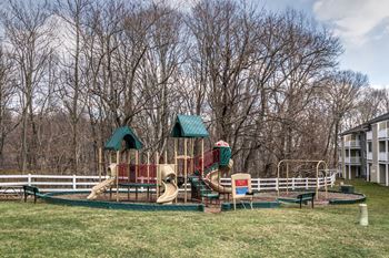 a playground with a swing set and slides at Ellicott Grove, Ellicott City, 21043