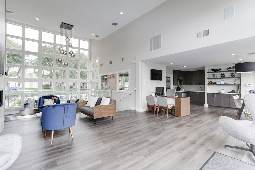 a living room filled with furniture and a large window at Madison at Eden Brook, Maryland, 21046