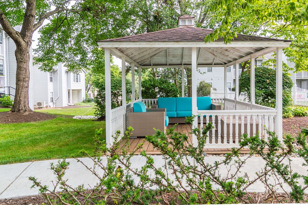 a white gazebo with a blue couch on it at Hamilton at Kings Place, Columbia, MD