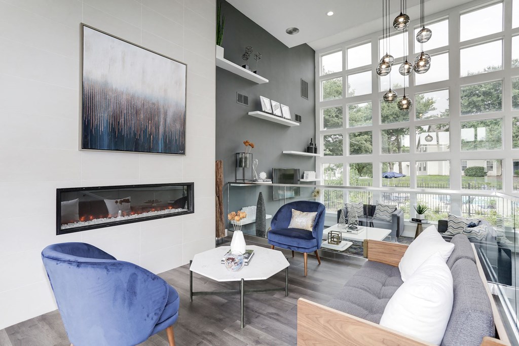 a living room with a large window and a fireplace at Madison at Eden Brook, Maryland