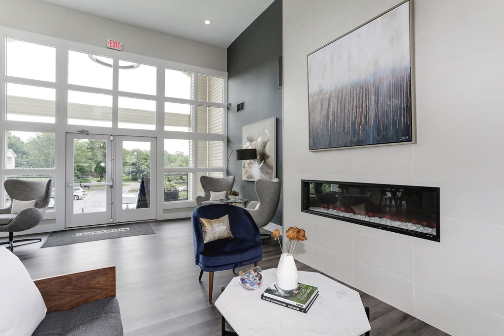 a living room with a blue chair and a white coffee table at Madison at Eden Brook, Columbia