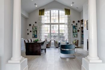 a living room with a large window and a table and chairs at Ellicott Grove, Ellicott City, MD