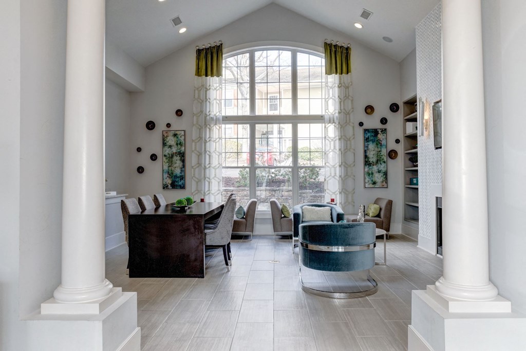 a living room with a large window and a table and chairs at Ellicott Grove, Ellicott City, MD