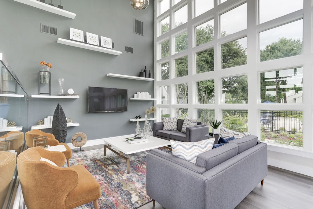a living room with a large wall of windows at Madison at Eden Brook, Columbia Maryland