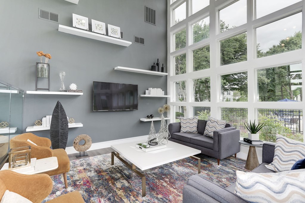 a living room with a large window and a tv on the wall at Madison at Eden Brook, Columbia, 21046