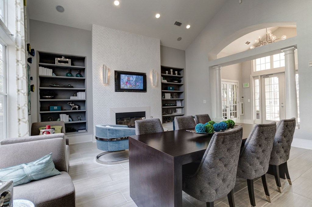a living room with a table and chairs in front of a fireplace at Ellicott Grove, Ellicott City