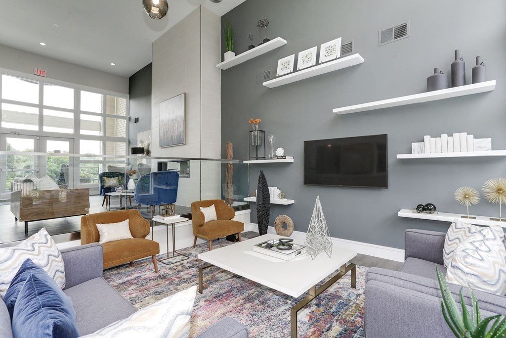 a living room with gray walls and a white coffee table at Madison at Eden Brook, Columbia, MD