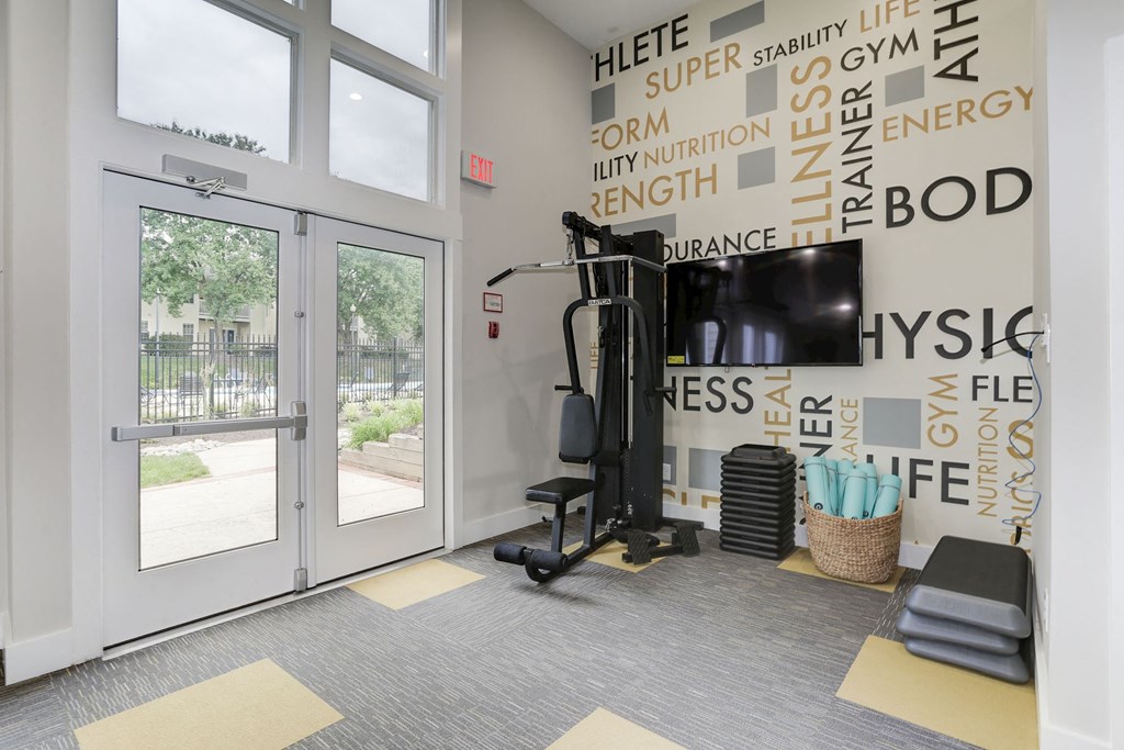 a gym with a treadmill and a tv on the wall at Madison at Eden Brook, Maryland, 21046