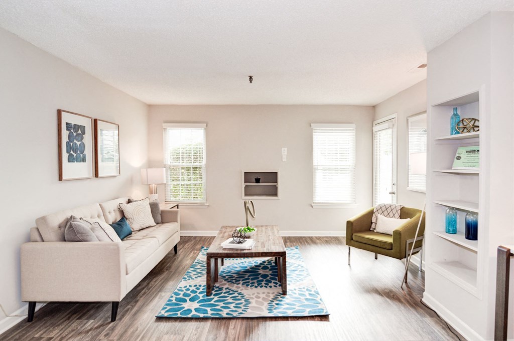 a living room with white walls and hardwood flooring at Hamilton at Kings Place, Columbia, MD 21046