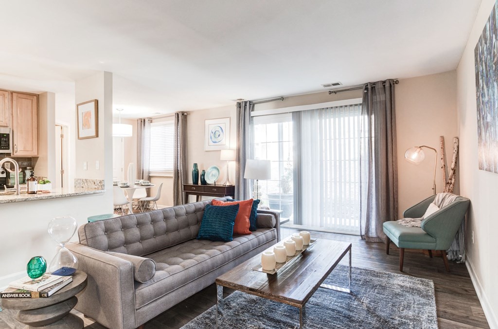 a living room with a gray couch and a coffee table in front of a sliding glass door at Ellicott Grove, Ellicott City Maryland