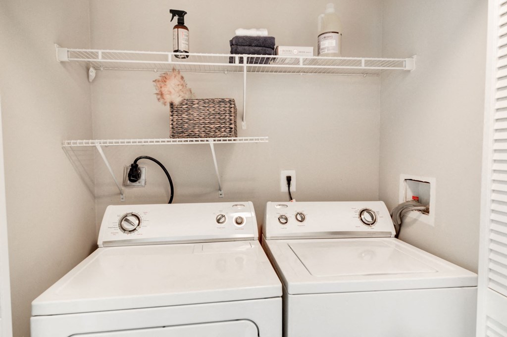 a small laundry room with two washers and a dryer at Hamilton at Kings Place, Maryland 