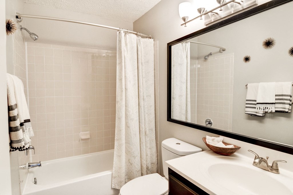 a bathroom with a shower toilet and sink at Hamilton at Kings Place, Columbia City