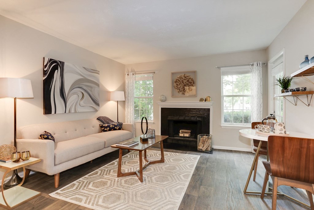 a living room with a fireplace and a couch at Madison at Eden Brook, Columbia, MD