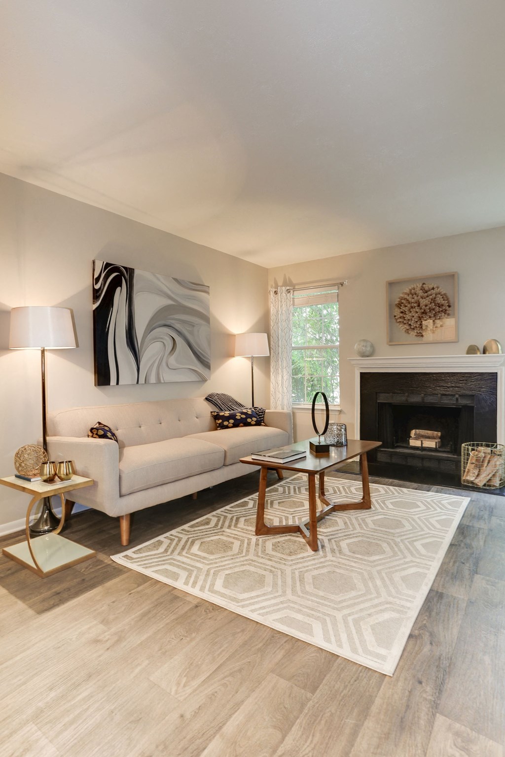 a living room with a couch coffee table and fireplace at Madison at Eden Brook, Columbia, MD 21046