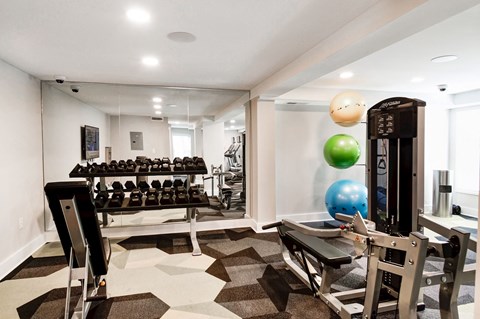 a spacious fitness room with weights and other exercise equipment at Hamilton at Kings Place, Columbia, MD, 21046