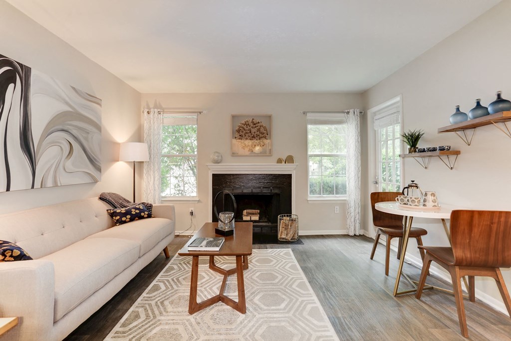 a living room with a couch table and chairs and a fireplace at Madison at Eden Brook, Maryland, 21046