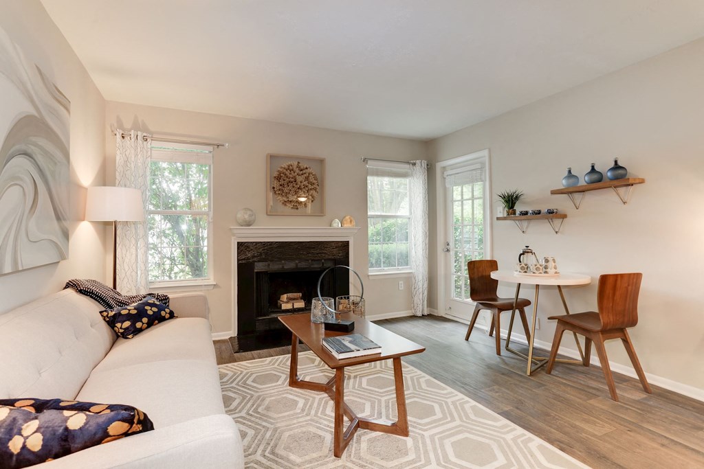 a living room with a couch table and chairs and a fireplace at Madison at Eden Brook, Maryland