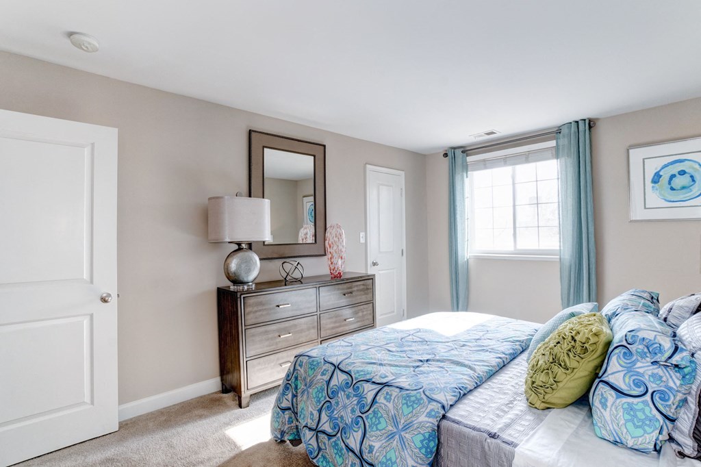 a bedroom with a bed and a dresser with a mirror at Ellicott Grove, Ellicott City