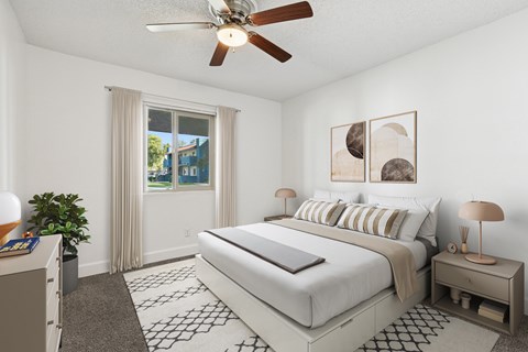 A bedroom with a large bed, a ceiling fan, and a window with curtains at Riviera Park, Chandler Arizona