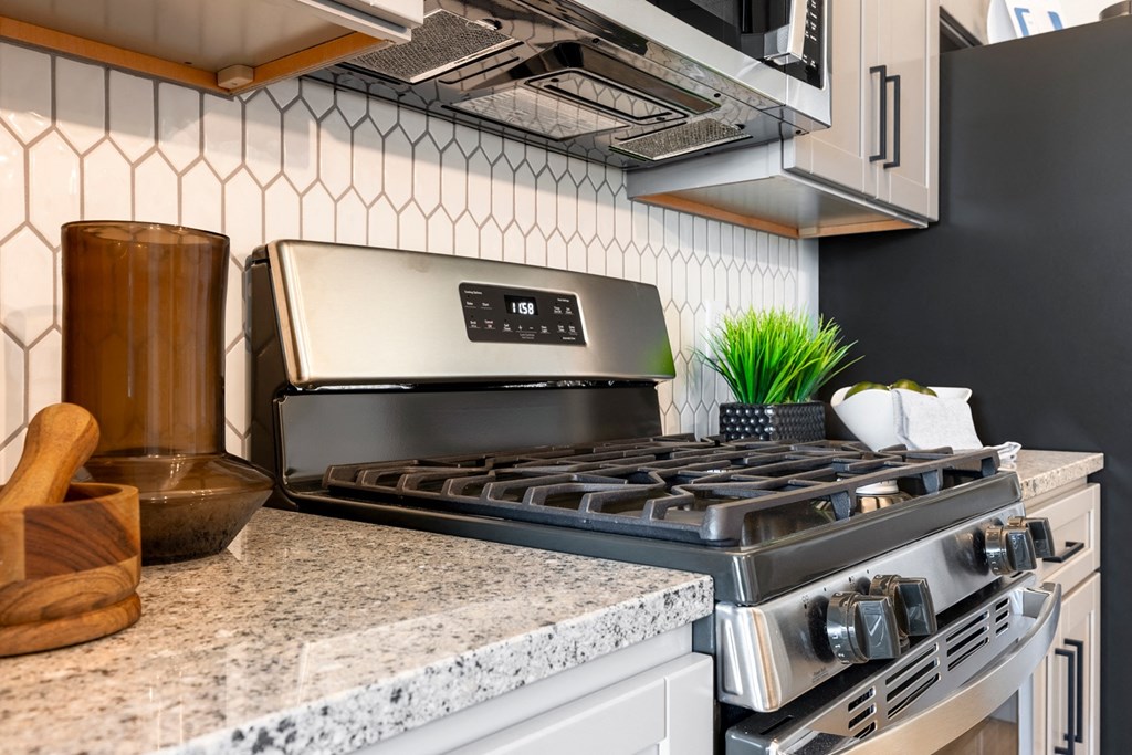 The Forge a kitchen with a stove and a microwave