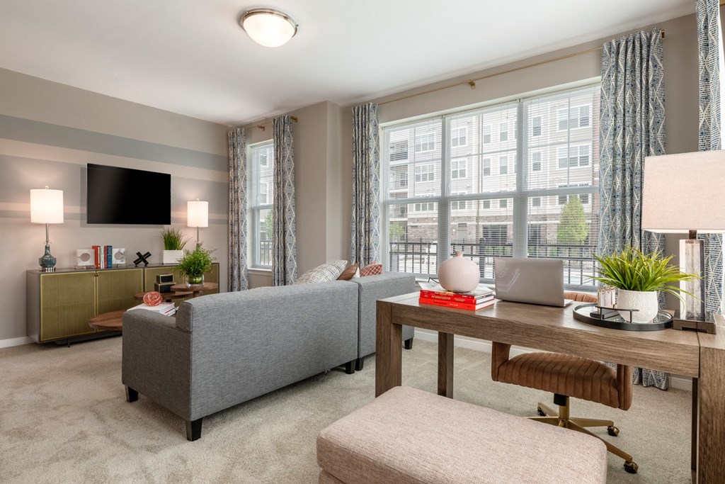 a living room with a couch and a table with a laptop