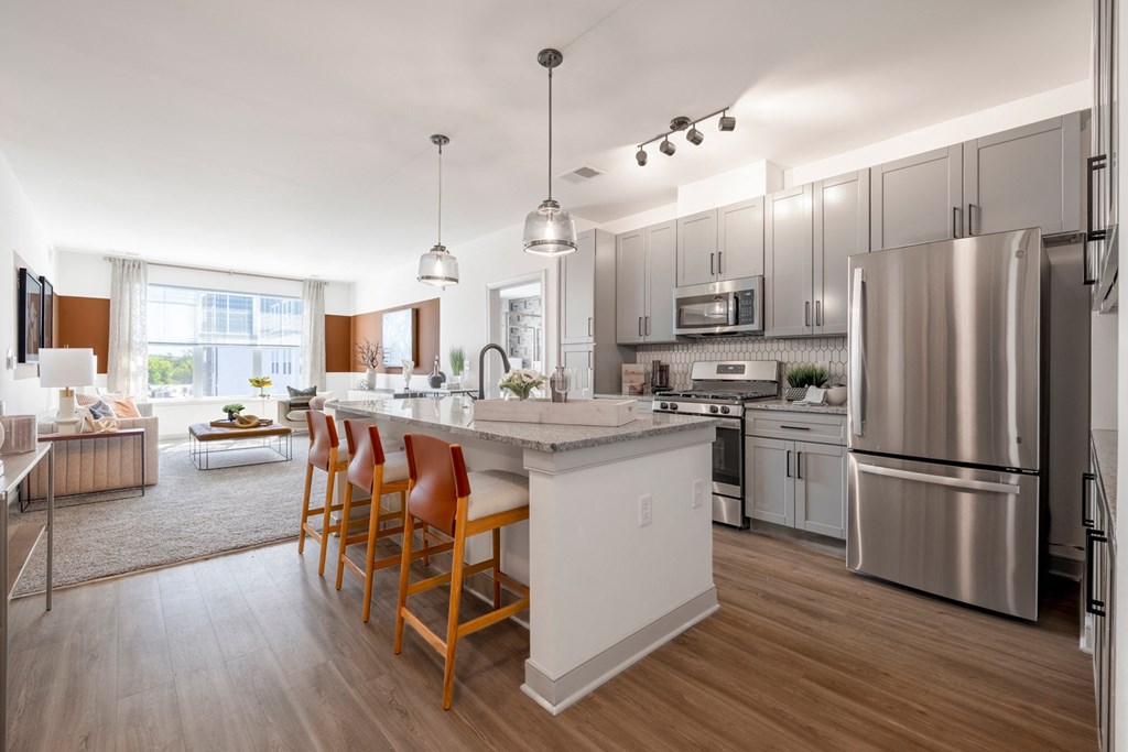 The Forge kitchen with stainless steel appliances and a large island with chairs
