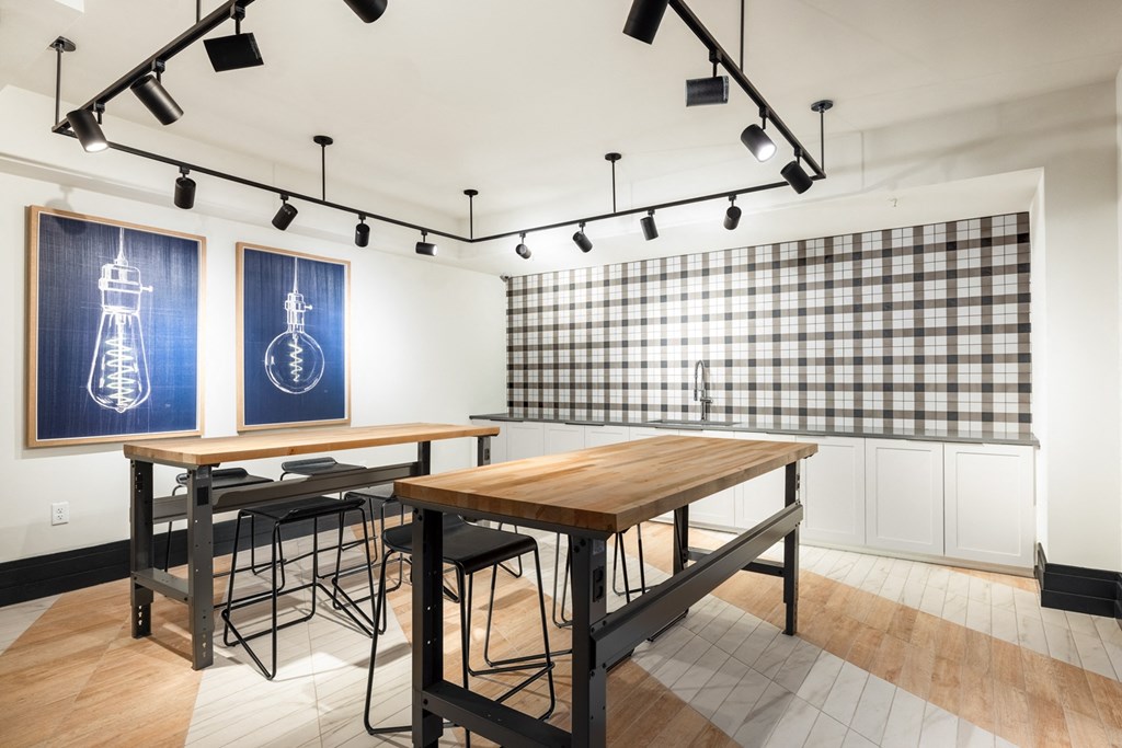 a conference room with two tables and two paintings on the wall