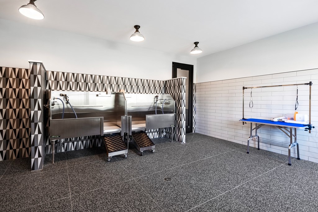 a meeting room with a table and chairs and a sink