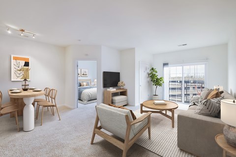 A living room with a grey couch, a wooden chair, a white table, and a television.