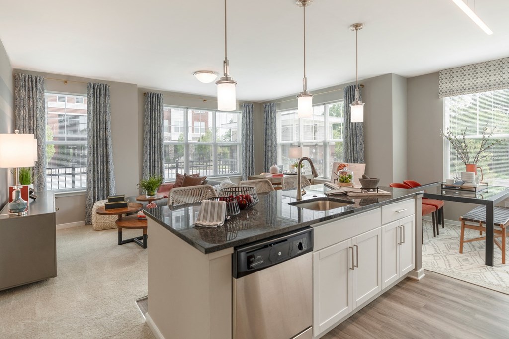 The Refinery kitchen with a large island and a living room in the background