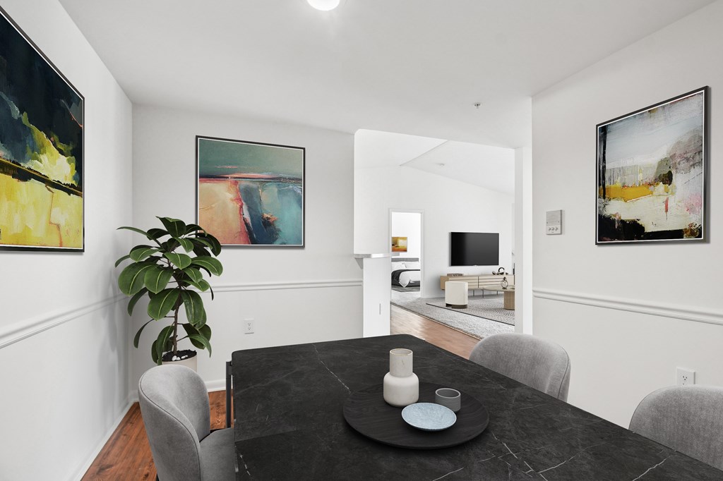 A dining room with a table set for two.