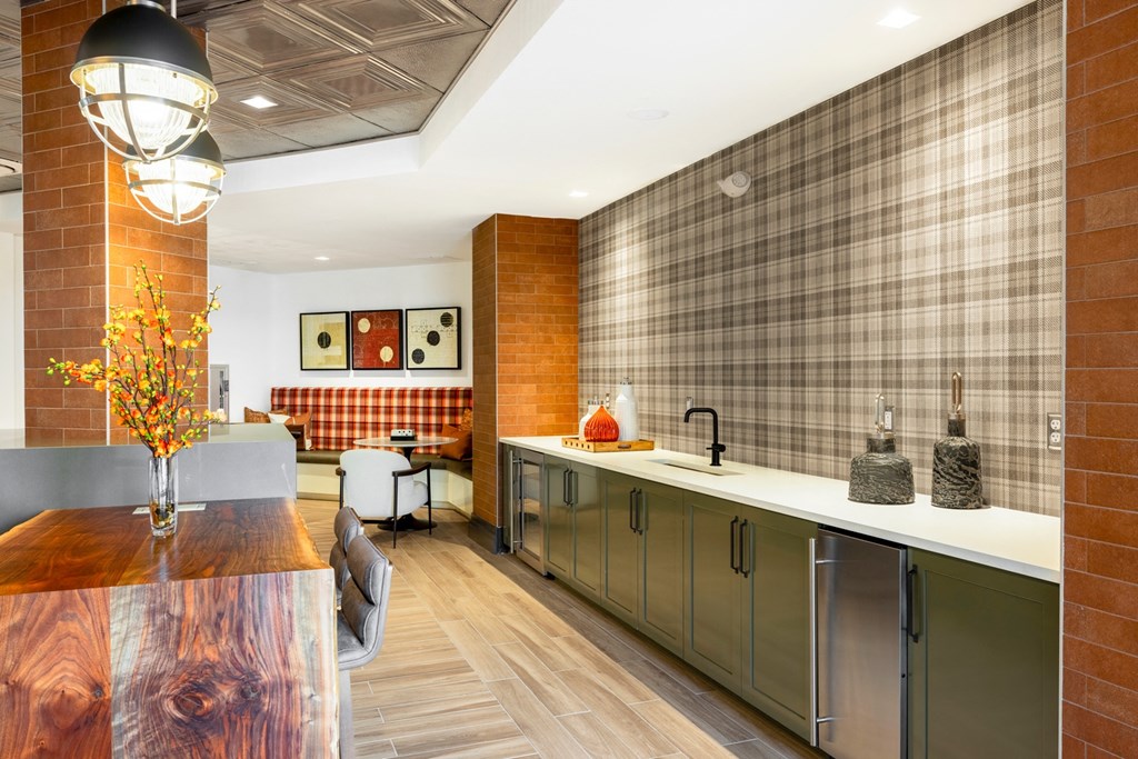 a kitchen with a long counter and a dining room in the background